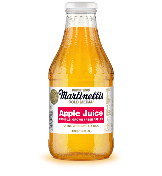 Bottle of Martinelli's Gold Medal Apple Juice on a white background
