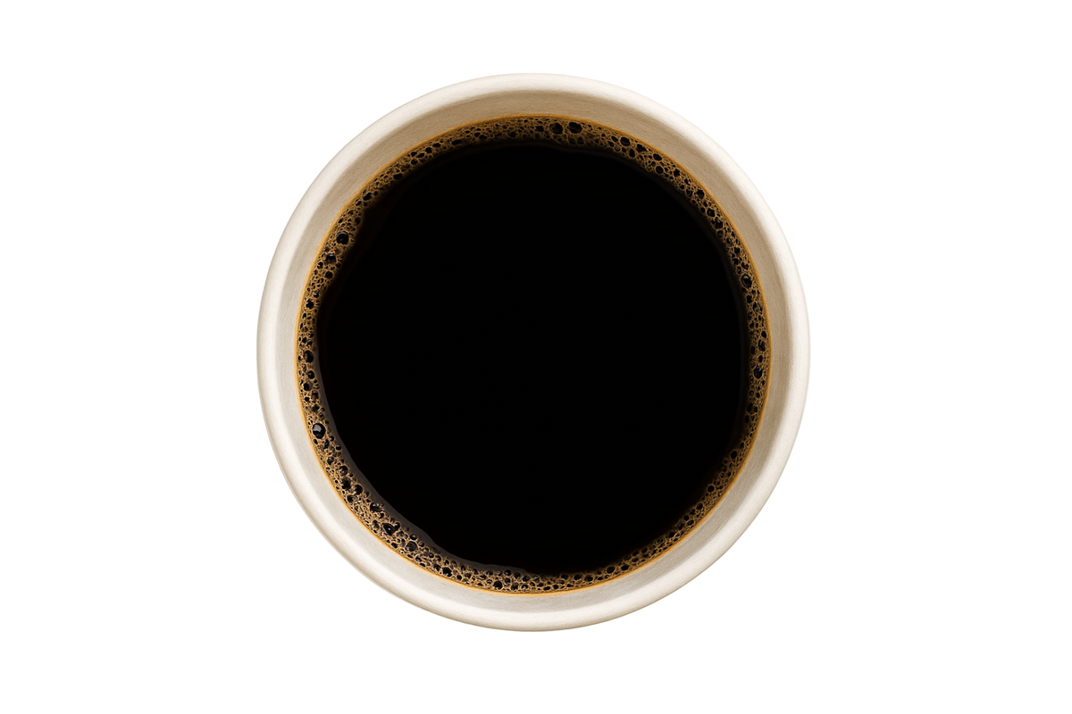 White cup filled with black coffee on a light gray background
